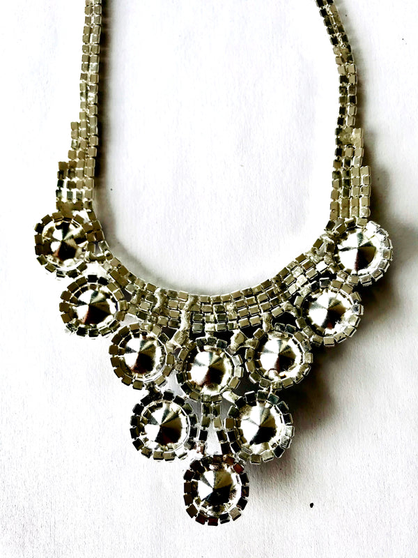 Silver beaded necklace on a white background
