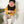 Load image into Gallery viewer, A baby wearing a black bandana bib and a yellow top, sitting and smiling.
