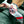 Load image into Gallery viewer, Colorful patterned handbag strap draped over a car seat.
