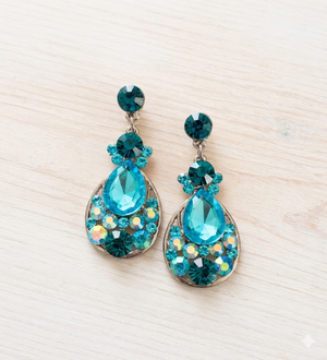 Pair of turquoise teardrop earrings on a light background