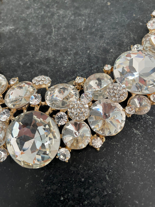 Close-up of a decorative brooch with crystals on a dark background