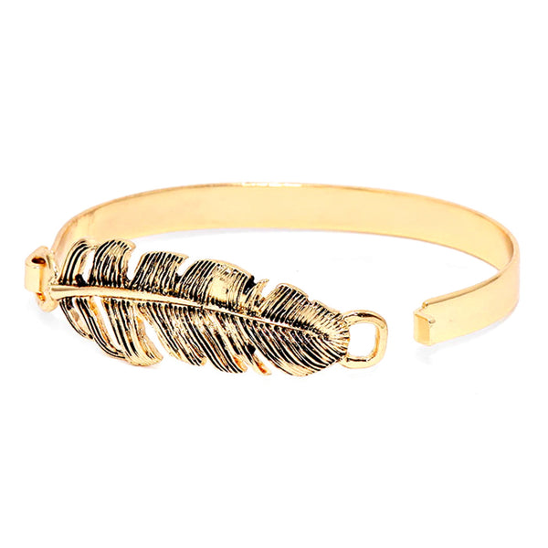 Gold feather-shaped bracelet on a white background