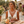Load image into Gallery viewer, Woman in a lace dress holding a bouquet of flowers in an outdoor setting.
