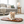 Load image into Gallery viewer, Small dog on a brown quilted mat in a living room.
