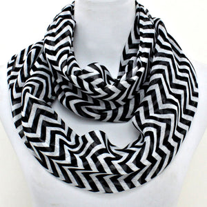 Black and white chevron patterned scarf on a mannequin with a white background