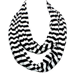 Black and white striped scarf on a mannequin against a gray background