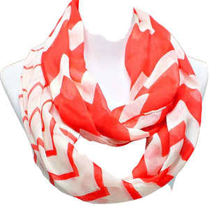Red and white patterned scarf on a mannequin against a gray background