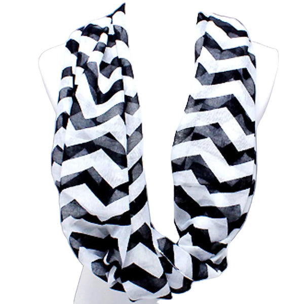 Black and white chevron patterned scarf on a mannequin against a light gray background