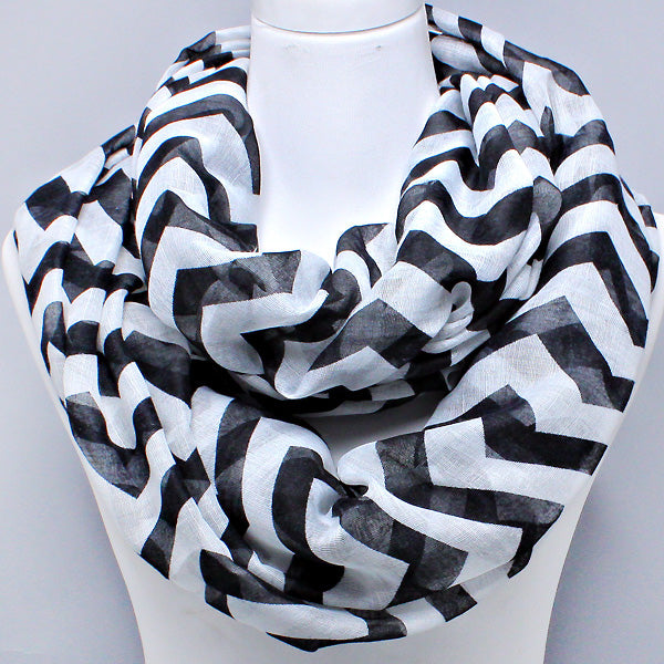 Black and white patterned scarf on a mannequin against a gray background