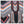 Load image into Gallery viewer, A close-up of a patterned garment or textile featuring bold geometric and tribal-inspired motifs in black, white, pink, orange, blue, and brown.

