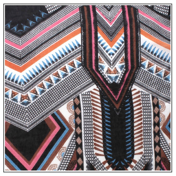 A close-up of a patterned garment or textile featuring bold geometric and tribal-inspired motifs in black, white, pink, orange, blue, and brown.