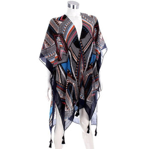 A lightweight, semi-sheer wrap shawl with a complex geometric tribal pattern in black, white, red, and blue, styled on a white mannequin torso against a plain white background.