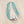 Load image into Gallery viewer, A multi-strand beaded necklace featuring turquoise blue beads with small coral accents, accented by a polished silver-toned cylindrical clasp and a hanging ring, shown on a plain white background.
