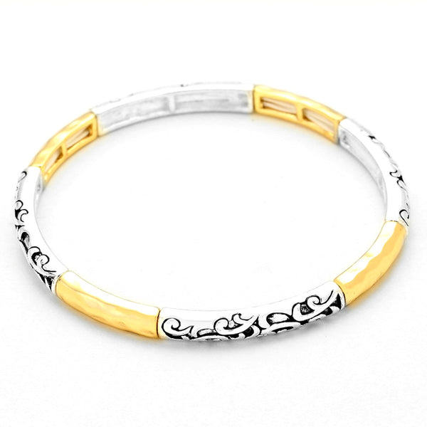 Two-tone silver and gold bracelet with black floral patterns on a white background