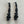 Load image into Gallery viewer, Pair of black earrings on a light gray textured surface
