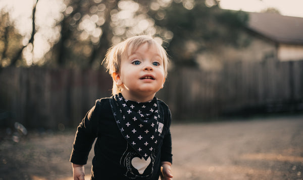 Child wearing a black outfit with star patterns outdoors