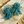 Load image into Gallery viewer, Turquoise beaded earrings on a textured surface with sand-like material
