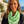 Load image into Gallery viewer, Woman wearing a green and white patterned scarf with a scenic background
