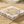 Load image into Gallery viewer, Silver bracelet with starfish designs on a stone block in a sandy setting

