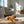 Load image into Gallery viewer, Dog chewing on a bone on a rug in a sunlit living room.
