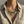 Load image into Gallery viewer, Necklace with sunflower design worn by a person in a beige shirt.

