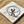 Load image into Gallery viewer, Silver bracelet with dragonfly design on a marble coaster with sand around
