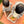 Load image into Gallery viewer, Two children with a basket of apples on an orange blanket outdoors.
