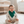 Load image into Gallery viewer, Baby sitting on a white rug in a nursery with a crib and dresser in the background.
