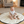 Load image into Gallery viewer, Baby sitting on a round play mat in a living room with toys around
