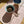 Load image into Gallery viewer, A pink pet food mat with a blue bowl containing pet food on top of it, placed on a wooden floor with a shadow falling on the mat.
