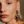 Load image into Gallery viewer, Close-up of a woman wearing a pair of ornate earrings with a neutral background
