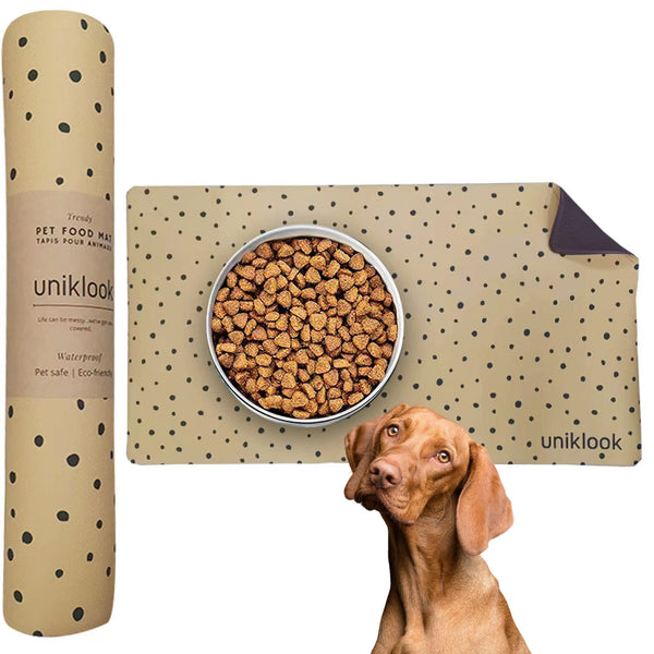A pet food mat with a cheetah pattern design, displayed next to its packaging and a dog lying in front of it.