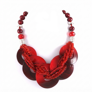 A red beaded statement necklace with large circular shell-like discs and matching drop earrings, displayed on a plain white background.
