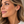 Load image into Gallery viewer, Matte gold ball stud earrings worn by woman

