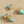 Load image into Gallery viewer, Turquoise and gold earrings on a sandy background
