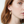 Load image into Gallery viewer, Close-up of a woman wearing gold hoop earrings with a plain background
