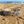 Load image into Gallery viewer, Silver bracelet with floral designs on a sandy beach
