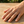 Load image into Gallery viewer, Hand wearing multiple small silver rings on a wooden surface
