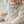 Load image into Gallery viewer, Baby wearing a gray and white triangle patterned bib.
