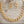 Load image into Gallery viewer, A gold-tone chain necklace and matching drop earrings displayed on a weathered light wood surface, with a small nail behind the earrings as a styling prop.
