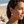 Load image into Gallery viewer, Woman wearing sun-shaped earrings on a beach
