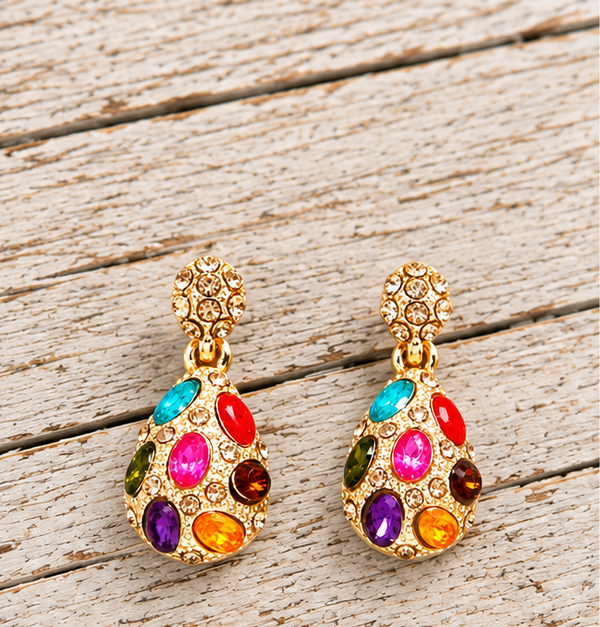 Gold plated multicolor rhinestone teardrop earrings on pale barn wood