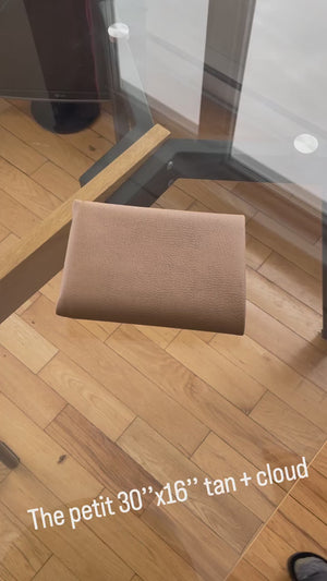 a video showing the tan and gray desk mat 