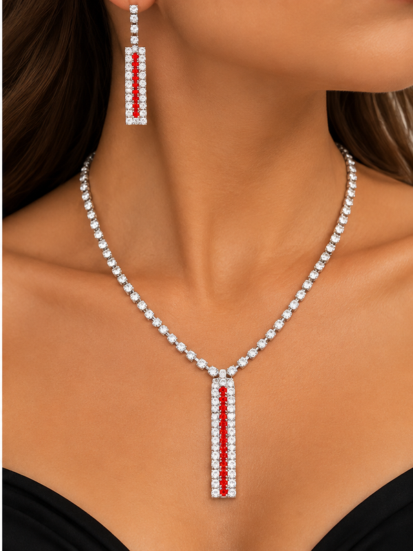 Red and clear crystal necklace and matching earrings worn by a woman