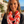 Load image into Gallery viewer, Woman wearing a red and white patterned scarf with a scenic background
