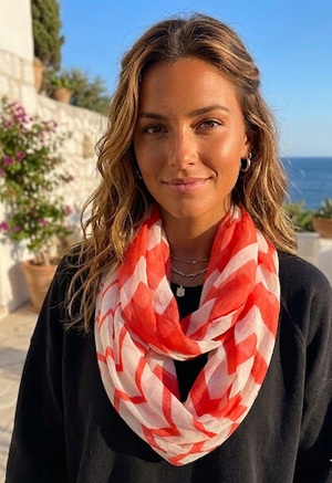 Woman wearing a red and white patterned scarf with a scenic background