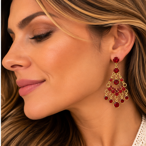 Woman wearing ruby red rhinestone gold-tone chandelier earring