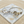 Load image into Gallery viewer, Two horse-themed bracelets on a marble coaster with sand around.

