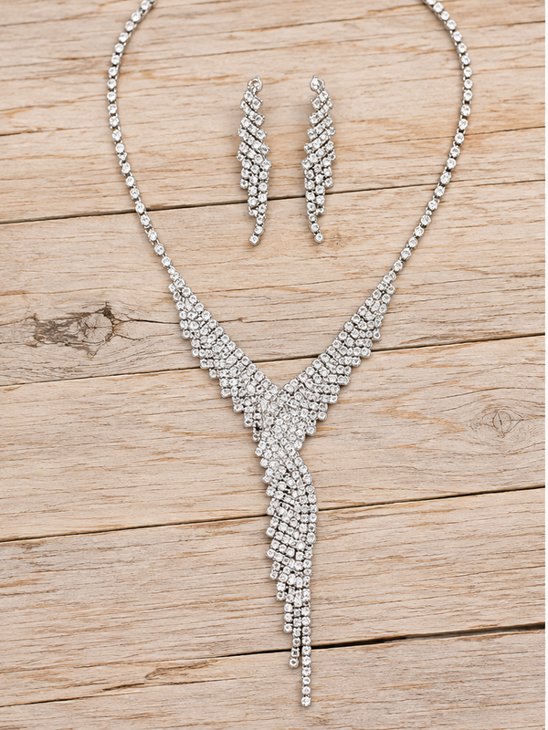 Silver rhinestone cascading necklace and earrings on pale rustic wood