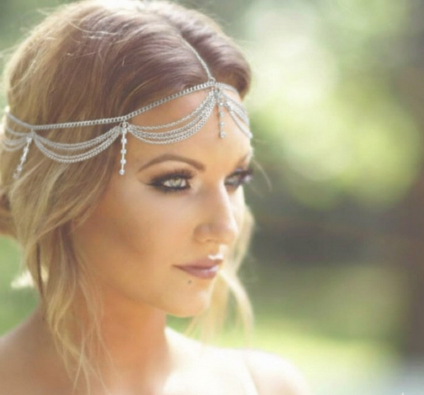 Woman wearing a decorative headband with a blurred natural background